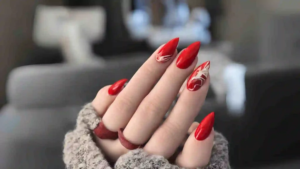 a beautiful hand with red almond nails