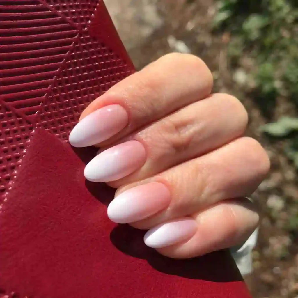 a hand with white ombre nails